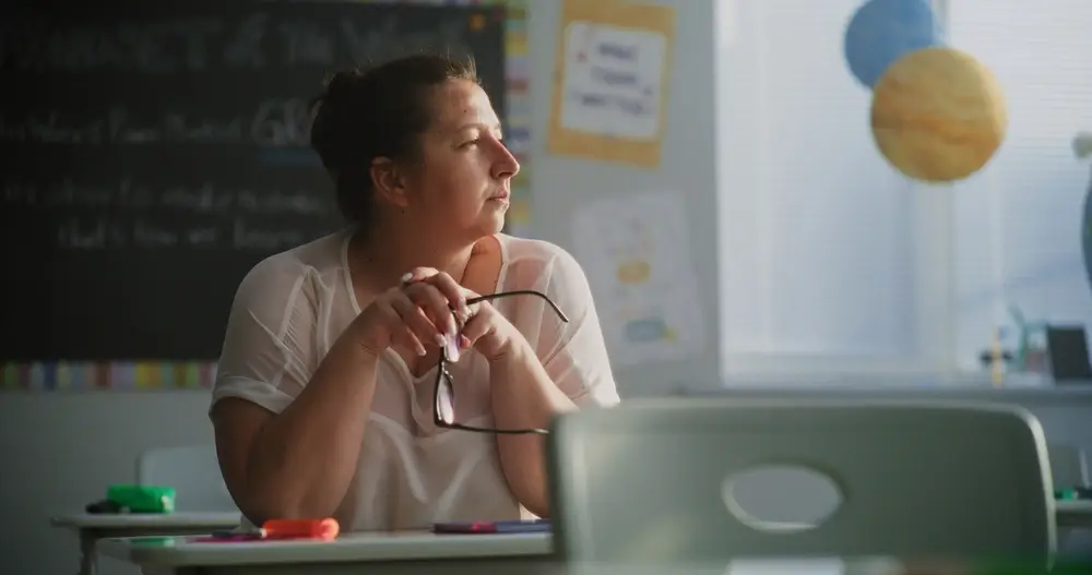 burnout lehrerin erschoepft nachdenklich klassenzimmer